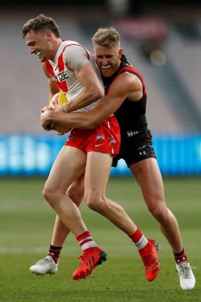 Dyson Heppell of the Bombers tackles Will Hayward of the Swans during the round 20 AFL match between Essendon Bombers and Sydney Swans at Melbourne...