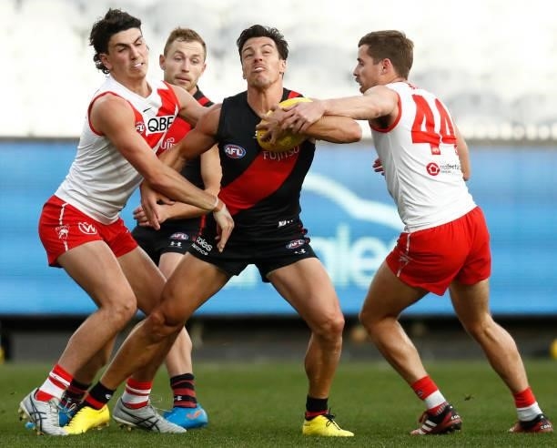 Dylan Shiel of the Bombers is tackled by Jake Lloyd of the Swans during the round 20 AFL match between Essendon Bombers and Sydney Swans at Melbourne...