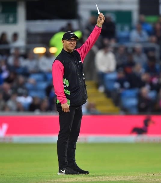Match official Alexander Wharf holds up the white five balls bowled card during The Hundred match between Northern Superchargers Men and Oval...