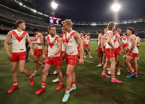 Sydney Swans players leave the ground after during the round 20 AFL match between Essendon Bombers and Sydney Swans at Melbourne Cricket Ground on...