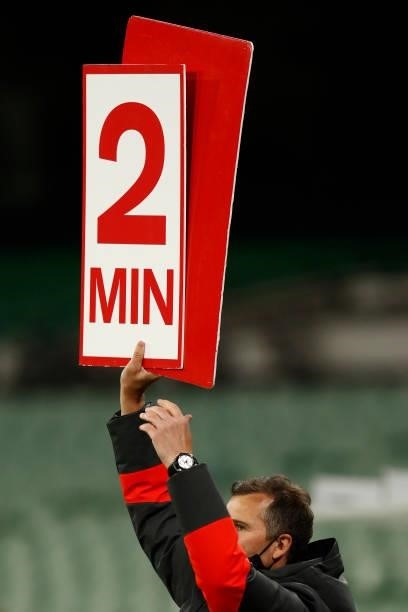Sydney Swans staff hold up sign from the interchange bench during the round 20 AFL match between Essendon Bombers and Sydney Swans at Melbourne...