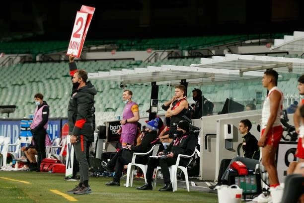 Sydney Swans staff hold up sign from the interchange bench during the round 20 AFL match between Essendon Bombers and Sydney Swans at Melbourne...
