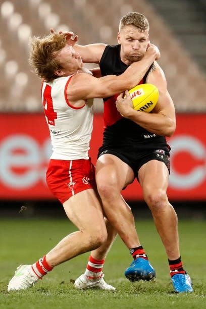 Jake Stringer of the Bombers takes Callum Mills of the Swans high with a fend off during the round 20 AFL match between Essendon Bombers and Sydney...