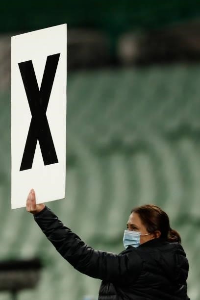 An Essendon staffer holds up a sign indicated the team has used all of its interchanges during the round 20 AFL match between Essendon Bombers and...