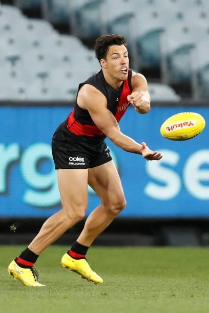 Dylan Shiel of the Bombers handballs during the round 20 AFL match between Essendon Bombers and Sydney Swans at Melbourne Cricket Ground on August...