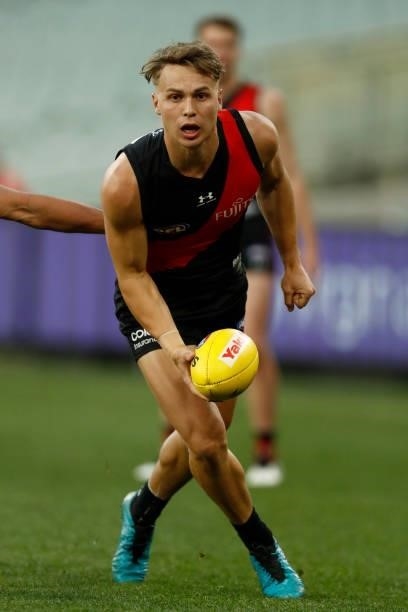 Dylan Clarke of the Bombers handballs during the round 20 AFL match between Essendon Bombers and Sydney Swans at Melbourne Cricket Ground on August...
