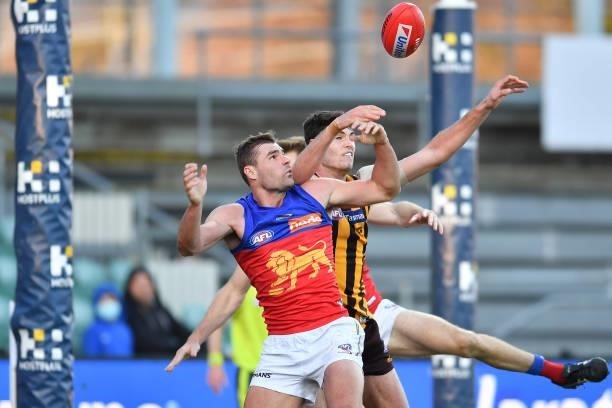 Ned Reeves of the Hawks and Jack Payne contests the ball during the round 19 AFL match between Hawthorn Hawks and Brisbane Lions at University of...