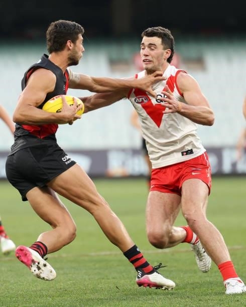 Kyle Langford of the Bombers and Justin McInerney of the Swans contest for the ball during the round 20 AFL match between Essendon Bombers and Sydney...
