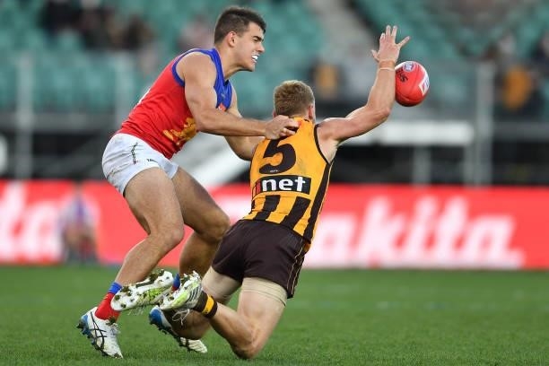 James Worpel of the Hawks is tackled by Brandon Starcevich of the Lions during the round 19 AFL match between Hawthorn Hawks and Brisbane Lions at...