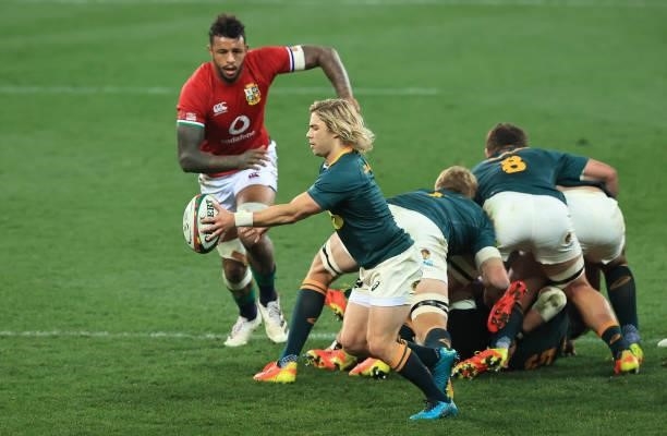 Faf de Klerk of South Africa kicks the ball past Courtney Lawes during the 2nd test match between South Africa Springboks and the British & Irish...