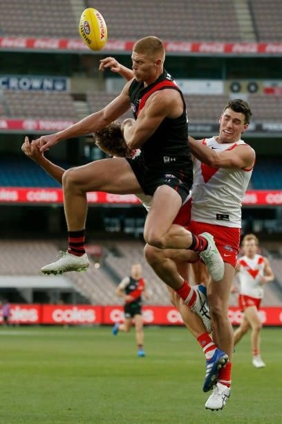 Jordan Dawson of the Swans is hit by Peter Wright of the Bombers in a marking contest during the round 20 AFL match between Essendon Bombers and...