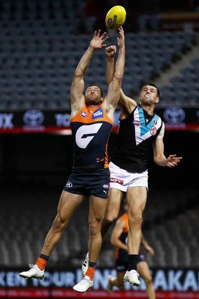 Sam J. Reid of the Giants and Ryan Burton of the Power contest the ball during the round 20 AFL match between Greater Western Sydney Giants and Port...