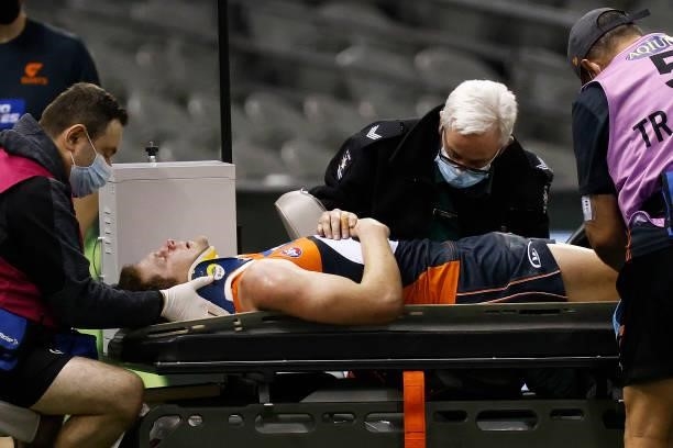 Jacob Hopper of the Giants is stretchered off the ground during the round 20 AFL match between Greater Western Sydney Giants and Port Adelaide Power...