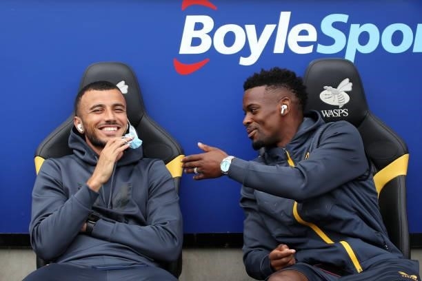 Romain Saiss and Nelson Semedo of Wolverhampton Wanderers react on the substituted bench prior to the Pre-Season friendly match between Coventry City...