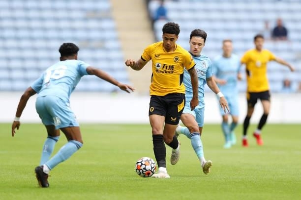 Ki-Jana Hoever of Wolverhampton Wanderers battles for possession with Callum O'Hare of Coventry City during the Pre-Season friendly match between...