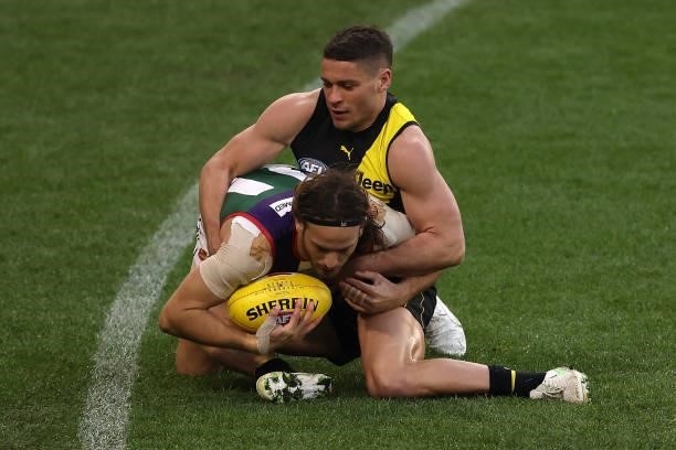 Dion Prestia of the Tigers tackles James Aish of the Dockers during the round 20 AFL match between Fremantle Dockers and Richmond Tigers at Optus...