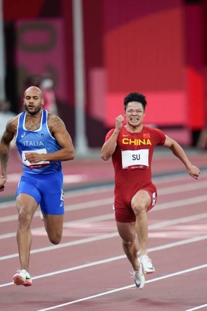 Lamont Marcell Jacobs of Italy and Su Bingtian of China compete in the Men's 100m Semi-Final on day nine of the Tokyo 2020 Olympic Games at Olympic...