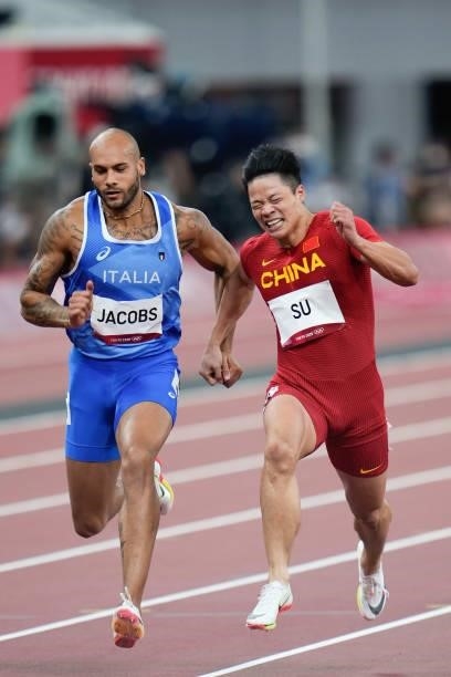 Lamont Marcell Jacobs of Italy and Su Bingtian of China compete in the Men's 100m Semi-Final on day nine of the Tokyo 2020 Olympic Games at Olympic...