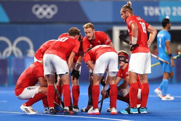 David Ames of Team Great Britain speaks with teammmates in a huddle prior to a penalty corner during the Men's Quarterfinal match between India and...