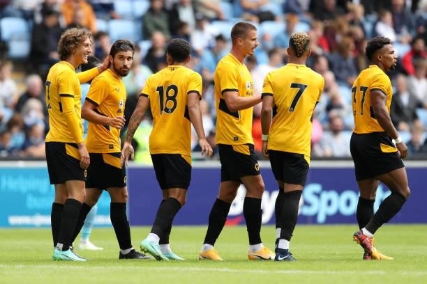Ruben Neves of Wolverhampton Wanderers celebrates with Fabio Silva and Morgan Gibbs-White after scoring their side's second goal during the...