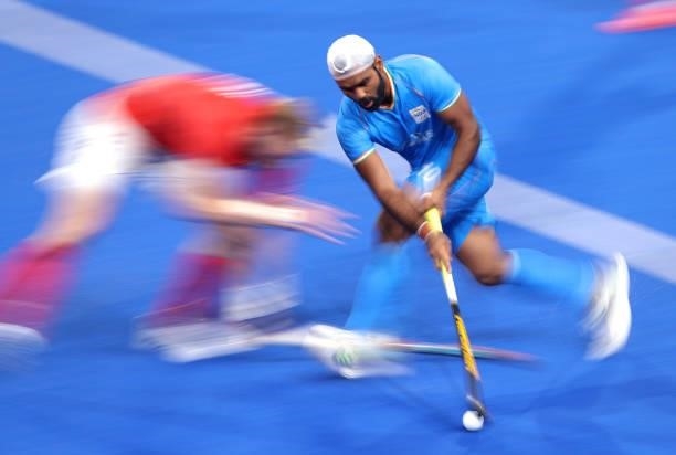 Simranjeet Singh of Team India runs with the ball whilst under pressure from gb during the Men's Quarterfinal match between India and Great Britain...