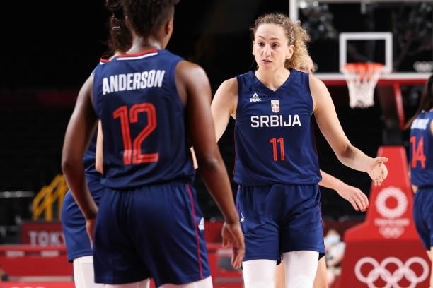 Aleksandra Crvendakic of Team Serbia reacts with teammate Yvonne Anderson during the second half of their Women's Basketball Preliminary Round Group...