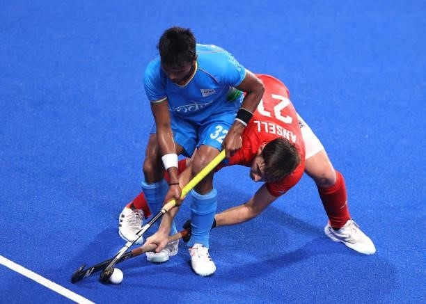 Vivek Sagar Prasad of Team India and Liam Paul Ansell of Team Great Britain battle for the ball during the Men's Quarterfinal match between India and...