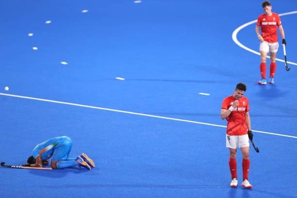 Harmanpreet Singh of Team India and Phillip Roper of Team Great Britain react following during the Men's Quarterfinal match between India and Great...