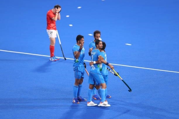 Dilpreet Singh and Nilakanta Sharma of Team India embrace whilst celebrating with teammates following the Men's Quarterfinal match between India and...