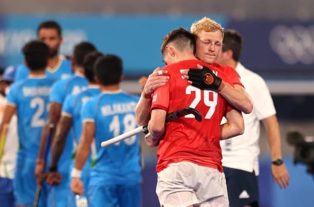 Rupert Scott Shipperley embraces teammate Thomas Sorsby of Team Great Britain following a loss in the Men's Quarterfinal match between India and...