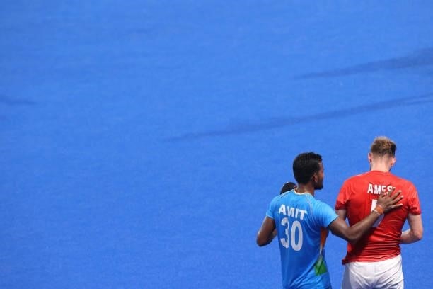 Amit Rohidas of Team India consoles David Ames of Team Great Britain following the Men's Quarterfinal match between India and Great Britain on day...