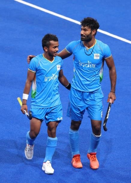 Varun Kumar and Surender Kumar of Team India leave the pitch following victory in the Men's Quarterfinal match between India and Great Britain on day...