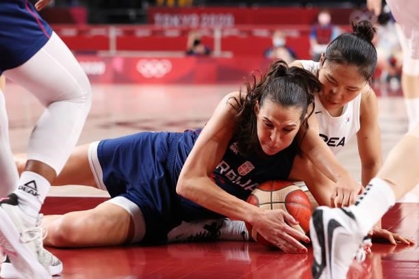 Sonja Vasic of Team Serbia and Danbi Kim of Team South Korea dive for a loose ball during the second half of a Women's Basketball Preliminary Round...