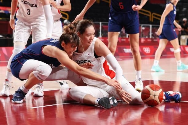 Tina Krajisnik of Team Serbia and Ji Su Park of Team South Korea dive for a loose ball during the second half of a Women's Basketball Preliminary...