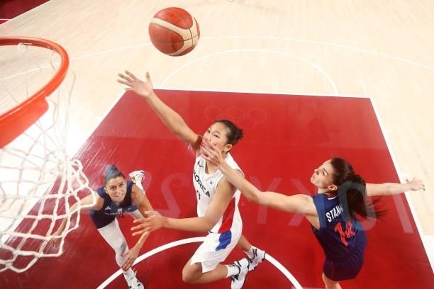 Danbi Kim of Team South Korea drives to the basket against Dragana Stankovic and Sasa Cado of Team Serbia during the second half of a Women's...