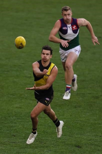 Daniel Rioli of the Tigers handballs during the round 20 AFL match between Fremantle Dockers and Richmond Tigers at Optus Stadium on August 01, 2021...