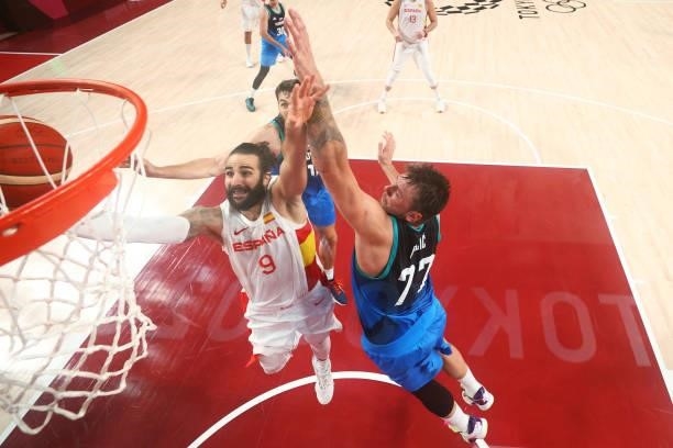 Ricky Rubio of Team Spain drives to the basket against Mike Tobey and Luka Doncic of Team Slovenia during the second half of a Men's Basketball...