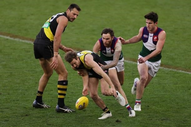 Kane Lambert of the Tigers contests for the ball against Nathan Wilson of the Dockers during the round 20 AFL match between Fremantle Dockers and...