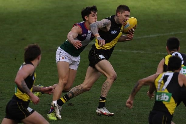 Matthew Parker of the Tigers looks to break from Adam Cerra of the Dockers during the round 20 AFL match between Fremantle Dockers and Richmond...