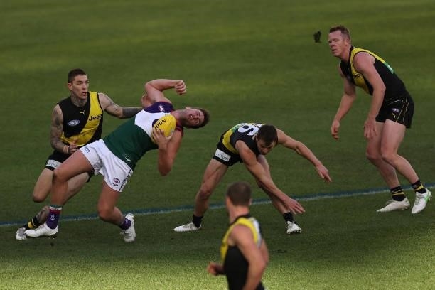 Luke Ryan of the Dockers gets taken high by Matthew Parker of the Tigers during the round 20 AFL match between Fremantle Dockers and Richmond Tigers...