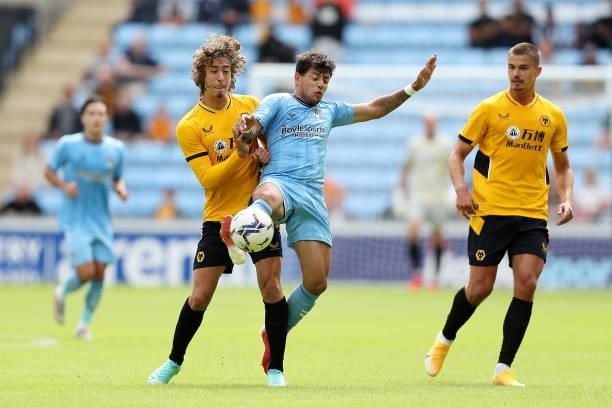 Fabio Silva of Wolverhampton Wanderers battles for possession against Gustavo Hamer of Coventry City during the Pre-Season Friendly between Coventry...
