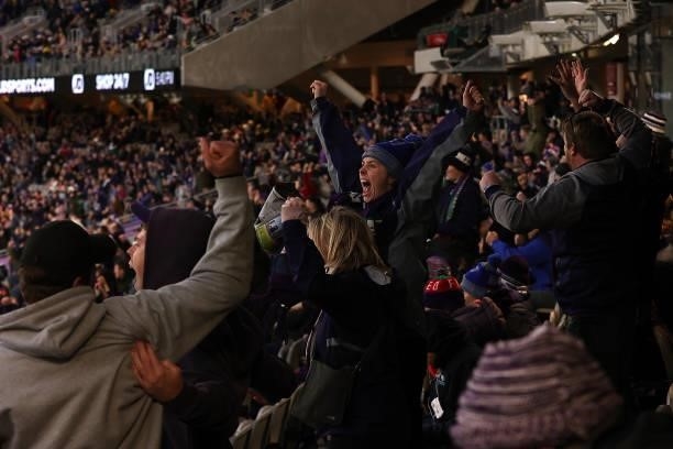 Fremantle fans celebrate winning the round 20 AFL match between Fremantle Dockers and Richmond Tigers at Optus Stadium on August 01, 2021 in Perth,...