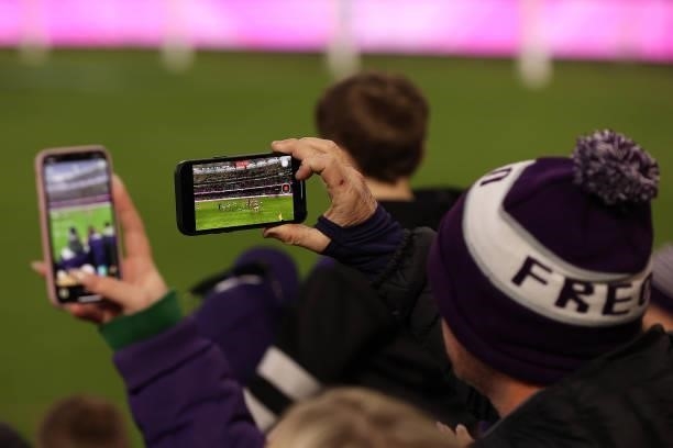 Spectators capture the team walking from the field on their mobile phones after winning the round 20 AFL match between Fremantle Dockers and Richmond...