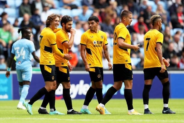 Ruben Neves of Wolverhampton Wanderers celebrates scoring his team's second goal with teammates during the Pre-Season Friendly between Coventry City...