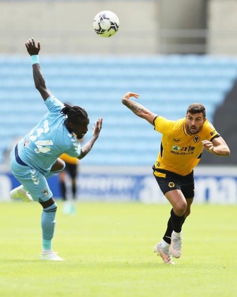 Patrick Cutrone of Wolverhampton Wanderers is challenged during the Pre-Season Friendly between Coventry City and Wolverhampton Wanderers at Ricoh...
