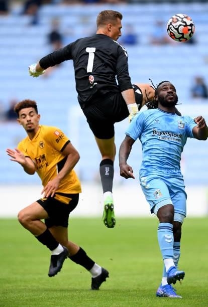 Simon Moore of Coventry and Frankaty Dabo of Coventry block out Rayan Ait-Nouri of Wolverhampton during the Coventry City v Wolverhampton Wanderers...
