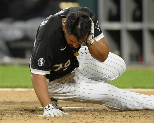 Jose Abreu of the Chicago White Sox falls to the ground after being hit by a pitch in the head thrown by James Karinchak of the Cleveland Indians on...