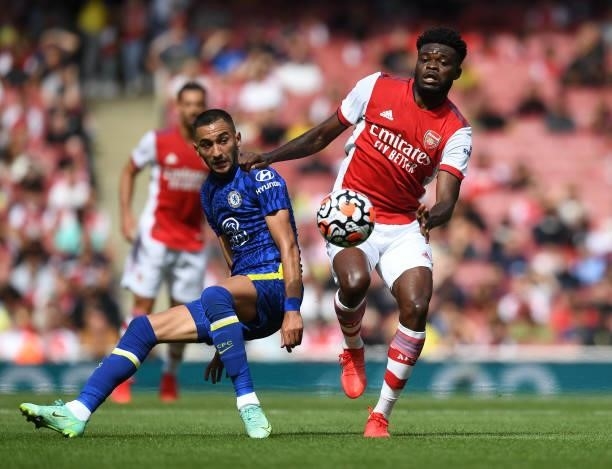 Thomas Partey of Arsenal breaks past Hakim Ziyech of Chelsea during the pre season friendly between Arsenal and Chelsea at Emirates Stadium on August...
