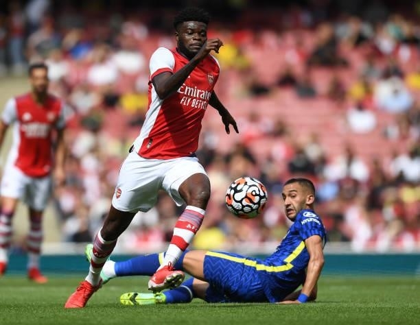 Thomas Partey of Arsenal breaks past Hakim Ziyech of Chelsea during the pre season friendly between Arsenal and Chelsea at Emirates Stadium on August...