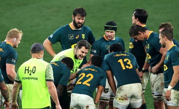 Rassie Erasmus, the Springboks director of rugby ,acting as a water carrier, talks to his team during the 2nd test match between South Africa...